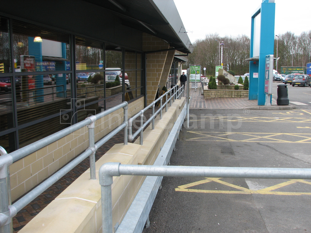 Interclamp galvanised double rail tube clamp guardrail constructed at a busy service station